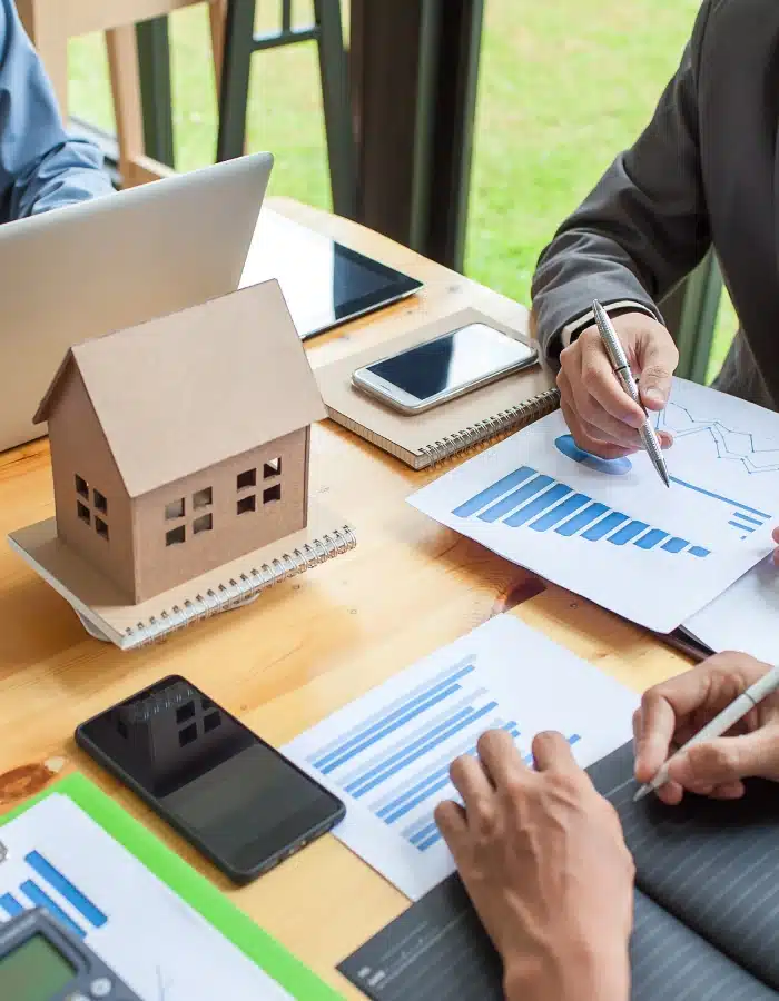 Strategic Estate Planning How Financial Planners Can Keep Their Client’s Estate Plan on the Right Track with their Education Savings Vehicles - business professionals working around a table with a small model home in the center